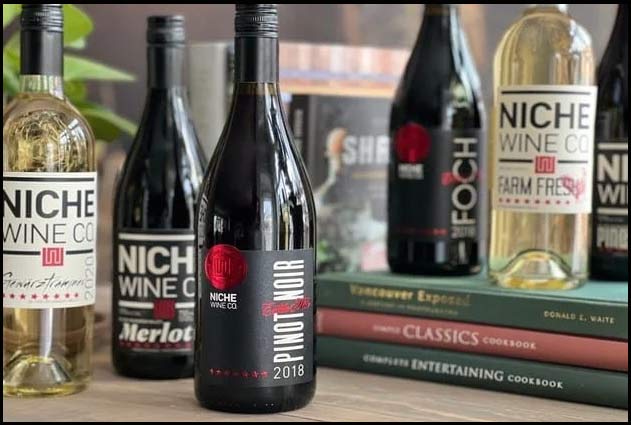 Niche Wine Co premium bottles on an elegant Okanagan patio at golden hour